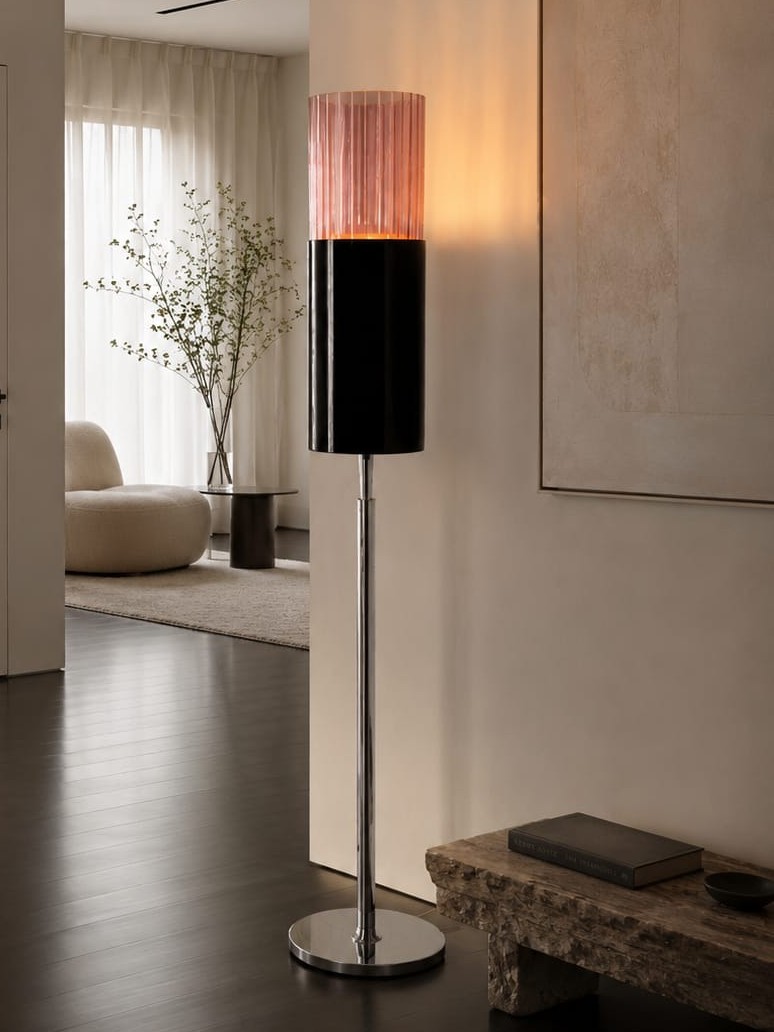 No. 013, Blush, a tall floor lamp with a glowing pink ribbed upper cylinder, dark lower cylinder, narrow reflective stem, and round base.