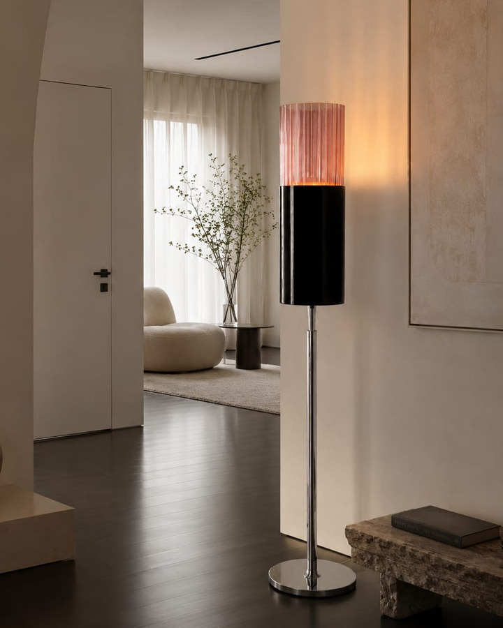 No. 013, Blush, a tall floor lamp with a glowing pink ribbed upper cylinder, dark lower cylinder, narrow reflective stem, and round base.