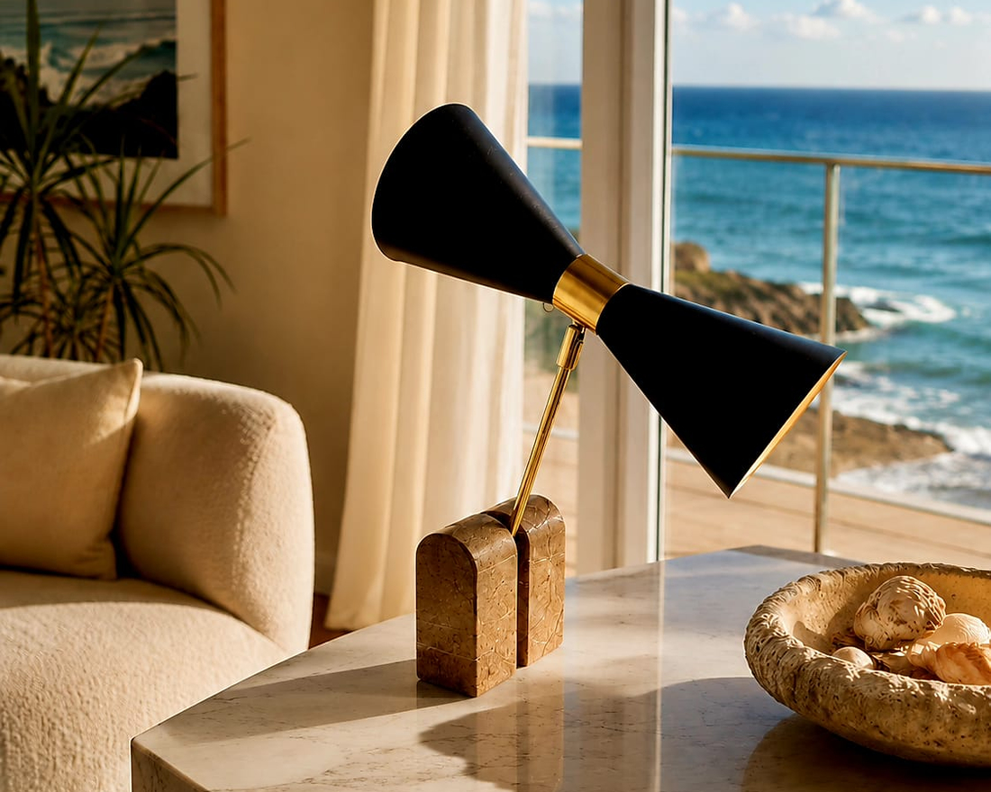 No. 018, Wingspan, a table lamp with two opposing matte-black cones, a polished warm-toned central collar, angled support, and two block-like feet.