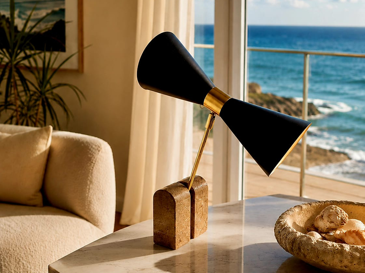 No. 018, Wingspan, a table lamp with two opposing matte-black cones, a polished warm-toned central collar, angled support, and two block-like feet.