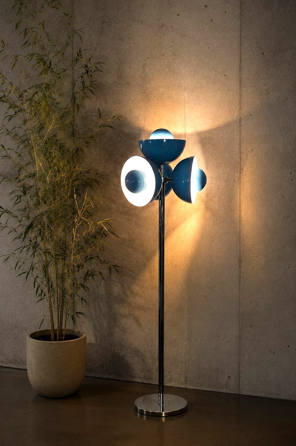 No. 030, Trine, three domed shades, blue and white, repeat up a slim chrome pole rising from a round base.