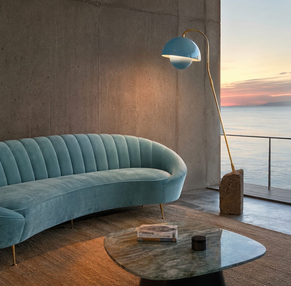 No. 031, Perch, a blue dome shade glows at the end of a curved brass arm arching from a slim upright.