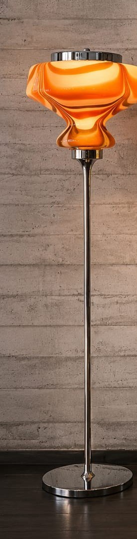 No. 040, Marmalade, a ribbed orange glass shade glows atop a slim chrome pole and round base.